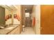 Bright bathroom featuring granite countertop, tiled shower, and modern fixtures at 4475 Rachel Blvd, Spring Hill, FL 34607