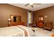 Well-lit bedroom with tile floors, dresser, and a pair of accent chairs under the window at 4475 Rachel Blvd, Spring Hill, FL 34607