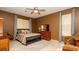 Comfortable bedroom featuring tile floors, light-blocking curtains, and neutral decor for a relaxing atmosphere at 4475 Rachel Blvd, Spring Hill, FL 34607