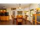 Cozy dining area featuring wood-look tile floors, a wooden table, and natural light from surrounding windows at 4475 Rachel Blvd, Spring Hill, FL 34607