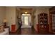 Inviting foyer features hardwood floors, a decorative cabinet, and a glass-paneled front door at 4475 Rachel Blvd, Spring Hill, FL 34607
