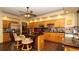 Modern kitchen with granite counters, seating at the island, stainless steel appliances, and wood cabinets at 4475 Rachel Blvd, Spring Hill, FL 34607