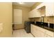 Well-lit laundry room offering tile floors, sink, counter space, and modern washer and dryer at 4475 Rachel Blvd, Spring Hill, FL 34607