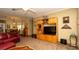 Living room showcases built-in shelving, a mounted television, and views into the adjacent dining area at 4475 Rachel Blvd, Spring Hill, FL 34607