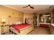 Comfortable main bedroom with a king-size bed, ceiling fan, and large window at 4475 Rachel Blvd, Spring Hill, FL 34607