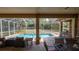 Relaxing poolside views from the covered patio offer ample seating and serene outdoor enjoyment at 4475 Rachel Blvd, Spring Hill, FL 34607