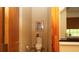 Neat powder room with nice molding, picture and window with blind, and a tiled floor at 4475 Rachel Blvd, Spring Hill, FL 34607