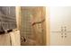 Neat shower with glass block wall, and tiled walls and floor, plus a towel rack at 4475 Rachel Blvd, Spring Hill, FL 34607