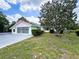 Charming single Gathering home with a spacious driveway and a lush green tree in the front yard at 4608 Mariner Blvd, Spring Hill, FL 34609