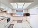 A well-lit kitchen is equipped with white appliances, ample counter space, and tile flooring at 4608 Mariner Blvd, Spring Hill, FL 34609