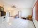Bright living room with tile floors, ceiling fan, and natural lighting at 4608 Mariner Blvd, Spring Hill, FL 34609