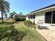 Relaxing backyard featuring a patio with lounge chairs, lush lawn, and beautiful landscaping at 4748 Yellowstone Dr, New Port Richey, FL 34655