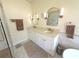 Bathroom featuring dual sinks, modern vanity, arched mirrors, and a separate shower stall at 4748 Yellowstone Dr, New Port Richey, FL 34655