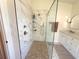 Updated bathroom with a glass-enclosed shower, marble tile, and modern vanity at 4748 Yellowstone Dr, New Port Richey, FL 34655