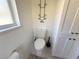 Powder room featuring toilet, decorative wall art, and storage cabinet at 4748 Yellowstone Dr, New Port Richey, FL 34655