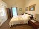 Bright bedroom features a comfortable bed, wood floors, and a charming window with natural light at 4748 Yellowstone Dr, New Port Richey, FL 34655