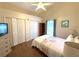 Bright bedroom featuring a bed, wood floors, closets, and a charming window with natural light at 4748 Yellowstone Dr, New Port Richey, FL 34655