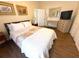 Well-lit bedroom featuring a cozy bed, wood floors, and a dresser with a mounted television at 4748 Yellowstone Dr, New Port Richey, FL 34655