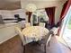 Cozy dining area with a round table, floral tablecloth, and adjacent kitchen featuring modern appliances at 4748 Yellowstone Dr, New Port Richey, FL 34655