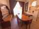 Formal dining room featuring a large wood table, decorative hutch, and window with sheer curtains at 4748 Yellowstone Dr, New Port Richey, FL 34655