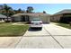 Charming single-story home with well-manicured lawn and a paved driveway leading to an attached garage at 4748 Yellowstone Dr, New Port Richey, FL 34655