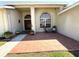 Inviting front porch with decorative tile, potted plants, chairs, and a view of the front door at 4748 Yellowstone Dr, New Port Richey, FL 34655