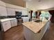 Modern kitchen with white cabinets, granite countertops, stainless steel appliances, and wood flooring at 4748 Yellowstone Dr, New Port Richey, FL 34655