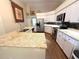 Bright kitchen with granite countertops, stainless steel appliances, white cabinets, and a breakfast bar at 4748 Yellowstone Dr, New Port Richey, FL 34655