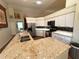 Well-lit kitchen featuring granite countertops, stainless steel appliances, a double sink, and white cabinetry at 4748 Yellowstone Dr, New Port Richey, FL 34655