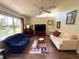 Comfortable living room with vaulted ceiling, stylish sofas, a ceiling fan, and plenty of natural light at 4748 Yellowstone Dr, New Port Richey, FL 34655