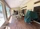 Relaxing screened patio with comfortable seating, a fan, and views of the outdoors at 4748 Yellowstone Dr, New Port Richey, FL 34655