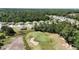Aerial view showing community; golf course view with a few golfers on the green at 5024 Diantha Way, Brooksville, FL 34604