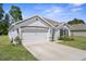 Beautiful home boasting a manicured lawn, two-car garage, and clean, white exterior with contrasting brown trim at 5024 Diantha Way, Brooksville, FL 34604