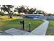Exterior of the grill featuring a grassy area and trees offering pleasant outdoor dining ambiance at 5024 Diantha Way, Brooksville, FL 34604