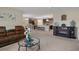 Inviting living room featuring neutral walls, fireplace, and a modern kitchen in an open-concept design at 5024 Diantha Way, Brooksville, FL 34604