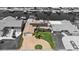 Monochrome aerial view of waterfront property with solar panels, dock, boat lift, and paver driveway at 5033 Cabrilla Ct, New Port Richey, FL 34652