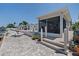 A spacious backyard featuring pavers, a screened-in porch, and walkway leading to other areas at 5033 Cabrilla Ct, New Port Richey, FL 34652