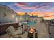 Backyard with a fire pit, lounge chairs, pool, hot tub, and patio area at 5033 Cabrilla Ct, New Port Richey, FL 34652