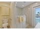 Bathroom with a glass enclosed shower, white toilet, and access to a pool area at 5033 Cabrilla Ct, New Port Richey, FL 34652