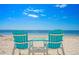 Tranquil beach scene with blue Adirondack chairs offering serene ocean views at 5033 Cabrilla Ct, New Port Richey, FL 34652