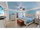 Spacious primary bedroom featuring a light blue ceiling, a ceiling fan, and a walk-in closet at 5033 Cabrilla Ct, New Port Richey, FL 34652