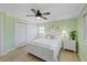 Cozy bedroom with light green walls, white furniture, and a ceiling fan for added comfort at 5033 Cabrilla Ct, New Port Richey, FL 34652