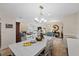 Bright dining room with modern chandelier that connects to the living room with fireplace at 5033 Cabrilla Ct, New Port Richey, FL 34652