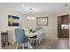 Bright dining room with modern light fixture, stylish decor and an adjacent kitchen area at 5033 Cabrilla Ct, New Port Richey, FL 34652