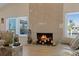 Bright living room fireplace with mantle and decor and two windows with blind coverings at 5033 Cabrilla Ct, New Port Richey, FL 34652