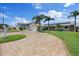 Home exterior features lush landscaping, a paver driveway, and a three-car garage at 5033 Cabrilla Ct, New Port Richey, FL 34652