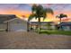 Charming home featuring a brick driveway, lush landscaping, solar panels and an attached two-car garage at 5033 Cabrilla Ct, New Port Richey, FL 34652