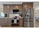 Kitchen features stainless steel appliances, updated cabinetry, and tile backsplash at 5033 Cabrilla Ct, New Port Richey, FL 34652