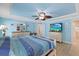 Spacious main bedroom with a television, ceiling fan, and serene decor at 5033 Cabrilla Ct, New Port Richey, FL 34652
