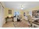 Bright home office with comfortable seating, built-in shelving, and natural light from the window at 5033 Cabrilla Ct, New Port Richey, FL 34652
